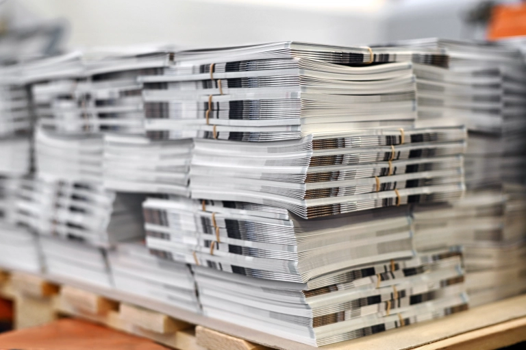 Printed brochures stacked together in piles
