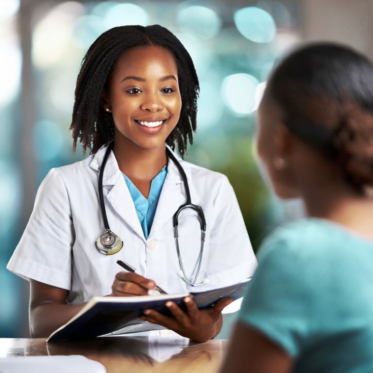 A compassionate healthcare professional in a medical office, showing a patient an empathetic and informative brochure