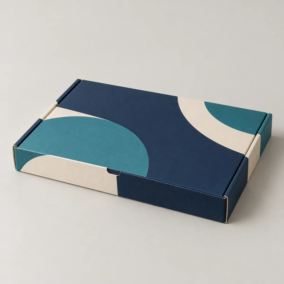 Illustrative printed mailer box with navy and teal geometric artwork