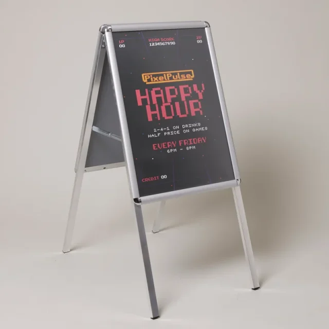 Silver aluminium A-frame with a printed happy-hour poster, shown open on its folding legs